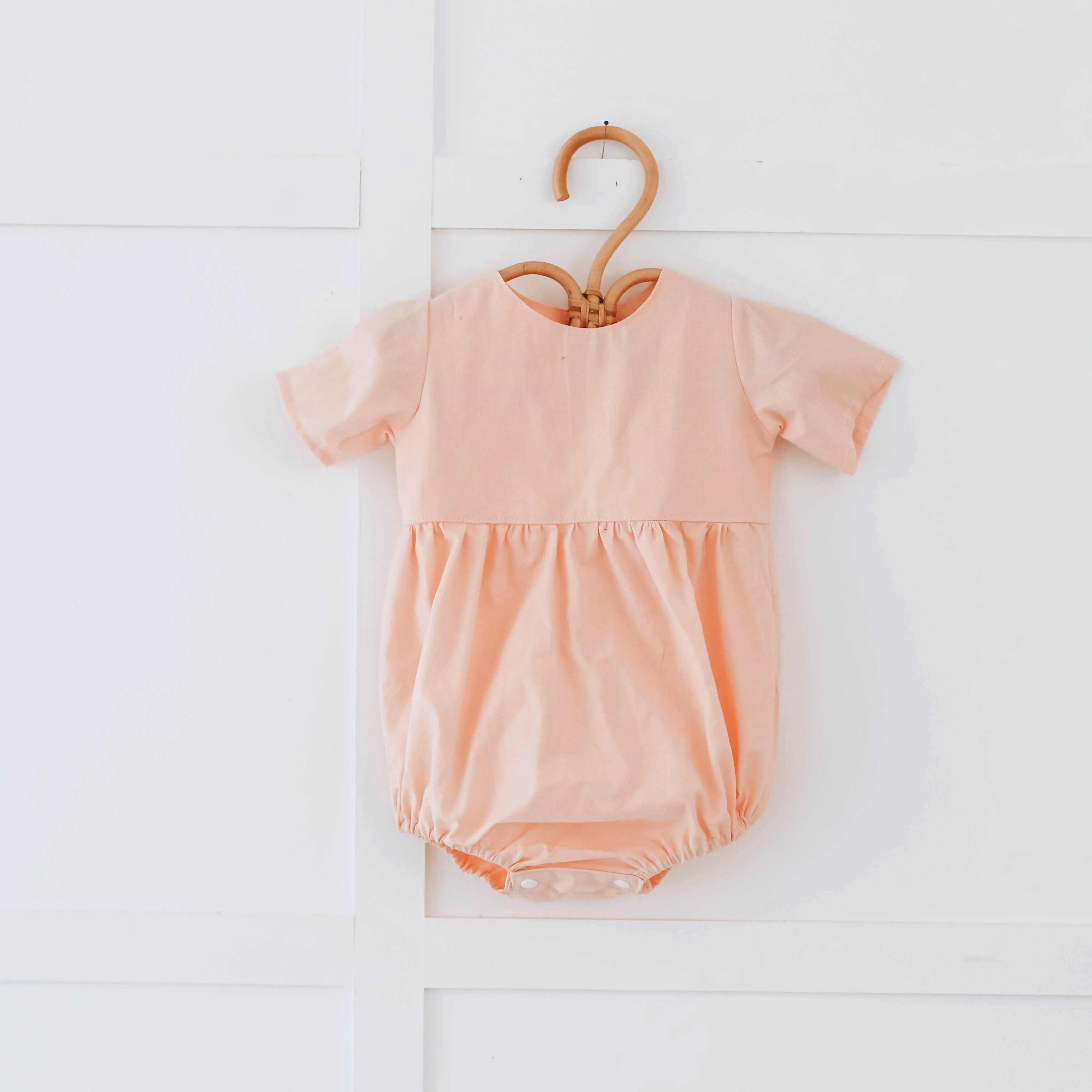 Peach romper with short sleeves